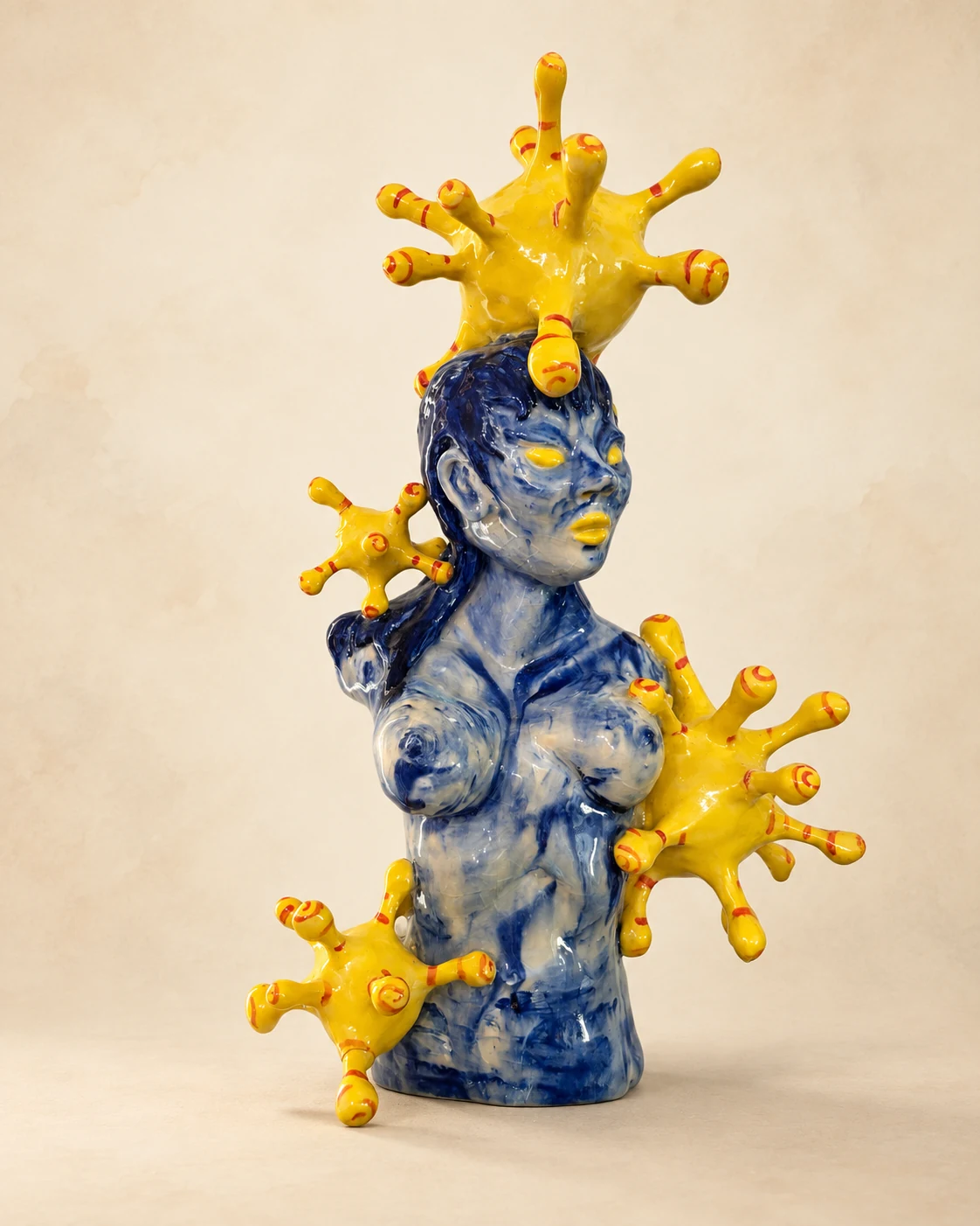 Glossy blue-and-white figurative bust with vivid yellow organic forms extending from the head, shoulder, torso, and side